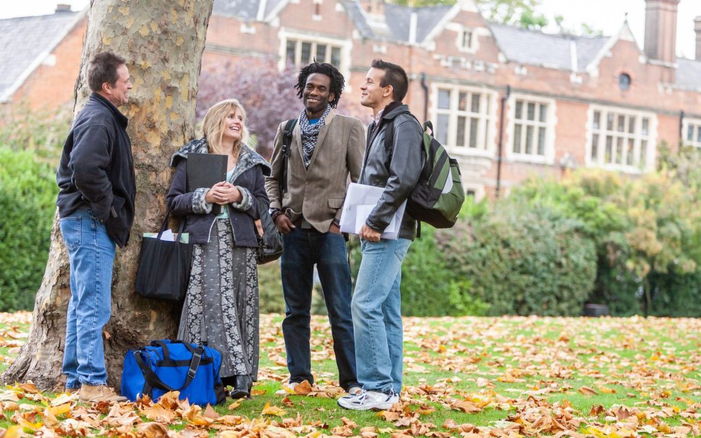 4 students stood by tree talking