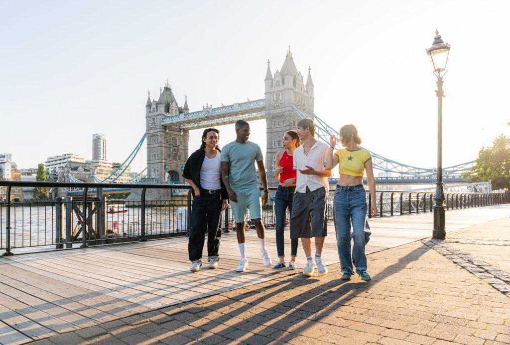Group of students walking with London Bridge in the background